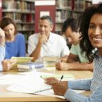 Mature students working in library